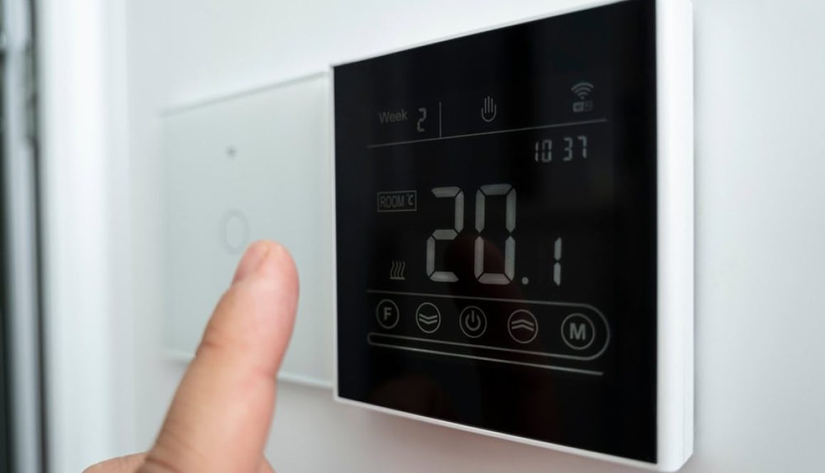 Close Up,Of,A,Male,Hand,Adjusting,A,Modern,Wall Mounted,Digital