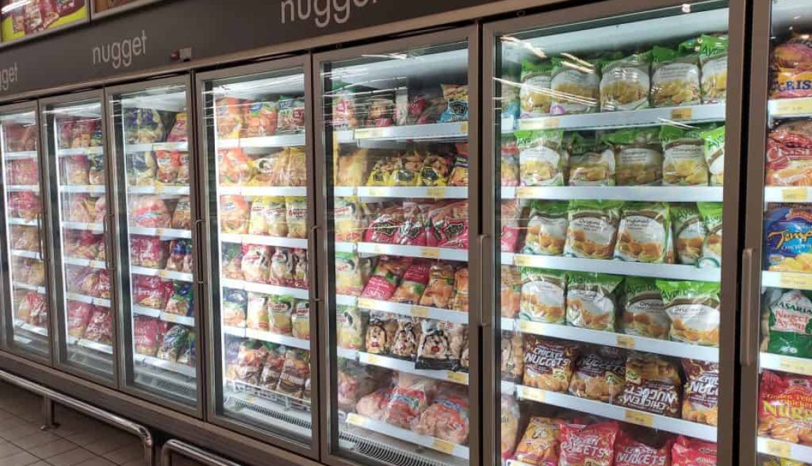 KUALA LUMPUR, MALAYSIA MARCH 16, 2020: Packed Chicken Nugget In Various Brand Placed In Display Chiller Refrigerator Inside The Huge Supermarket.