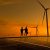 Silhouette,Engineer,Working,On,Solar,Cell,Roof,Plant,With,Windmill